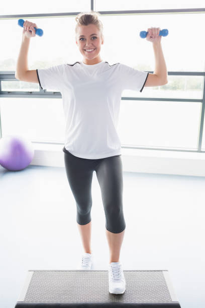 istock Female trainer lifting weights and doing aerobics 848047388
