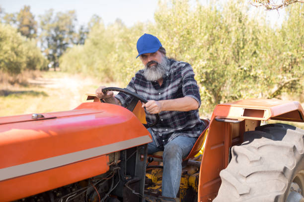 istock Portrait of confident man sitting in tractor 848047838