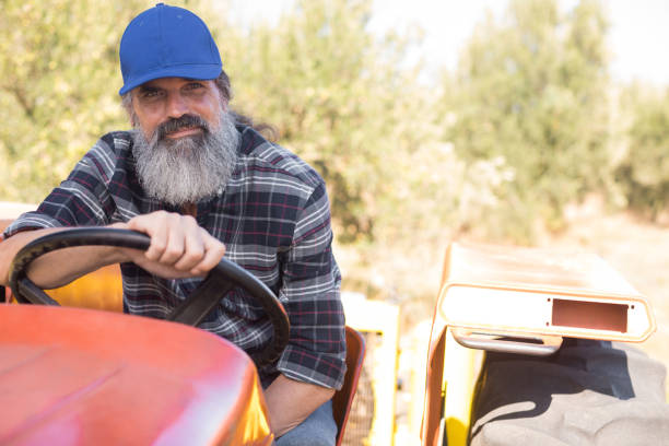 istock Portrait of confident man sitting in tractor 848047916