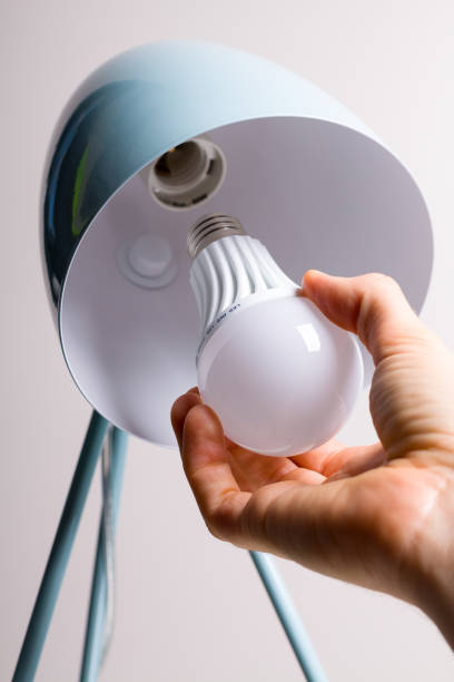 istock Changing the bulb for led bulb in table lamp in turquoise colours. 848061732