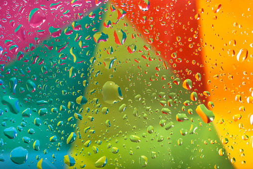 Drops of water on a colorful background. Shallow depth of field. Selective focus. Toned picture. Wallpaper concept.