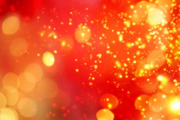 Christmas abstract red lights background. Festive xmas abstract background with bokeh defocused lights and stars. Card or invitation for your design\