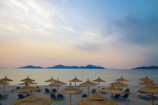 istock Row sunbeds and umbrellas on beach in morning. 848074808