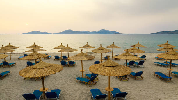 istock Row sunbeds and umbrellas on beach in morning. 848074942
