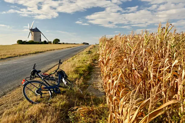 Enjoying break during bike trip near Moulin de Moidrey windmill in Normandy