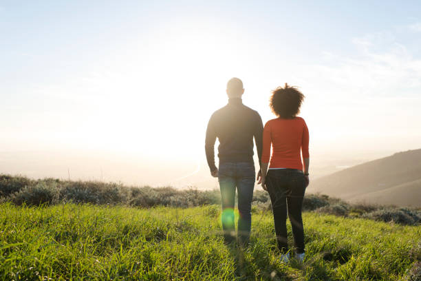 istock Couple standing and watching the sunset. 848081944