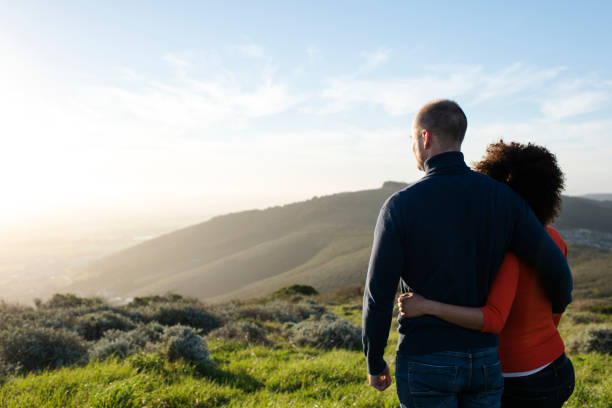 istock Couple standing and watching the sunset. 848082328