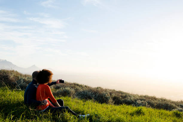 istock Couple sitting and watching the sunset 848082392