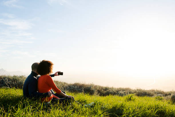 istock Couple sitting and watching the sunset 848082530