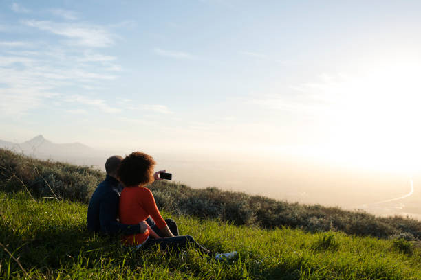 istock Couple sitting and watching the sunset 848085396