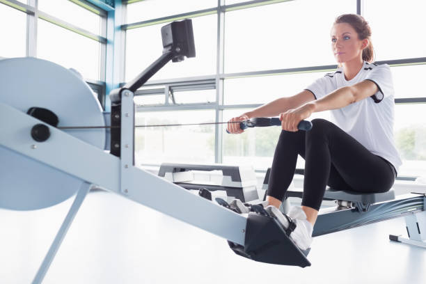 istock Concentrating woman training on row machine 848086386