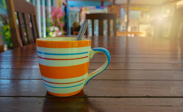 Coffee cup on wooden table in coffee cafe in morning