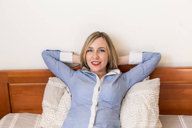 Young businesswoman resting on the bed stock photo