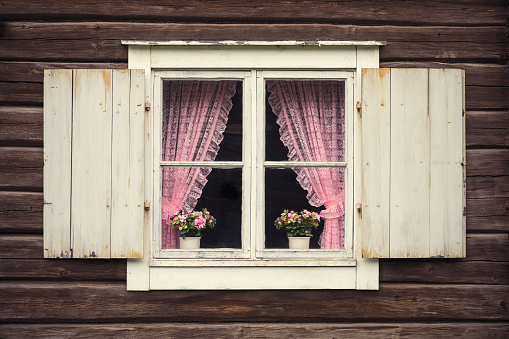 Two small wooden window with shutters on a old grey stone wall, space for text,  no person