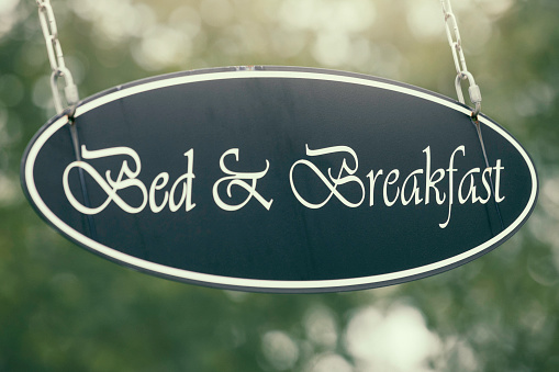 A hanging bed & breakfast sign.