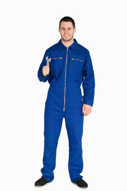 istock Smiling young mechanic in boiler suit with a wrench 848107040