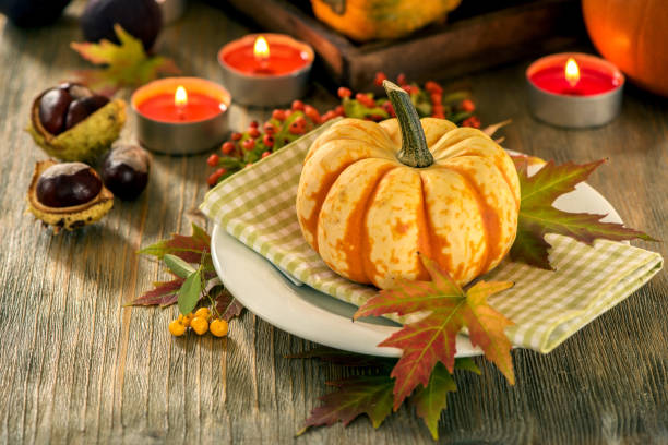 istock Autumn table setting with pumpkings and candles, fall home decoration for festive dinner 848111862