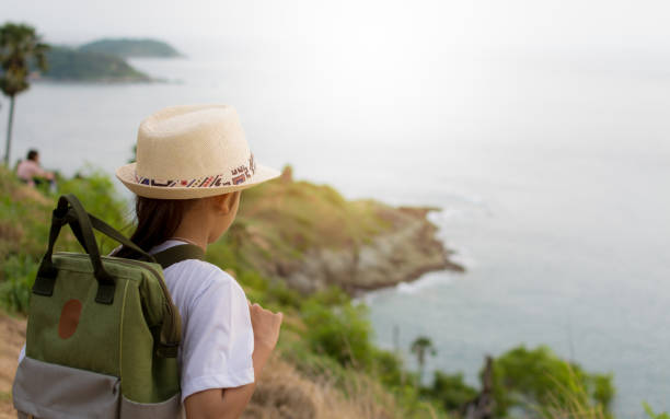 istock Cute girl with backpack viewing to the sea. 848122194