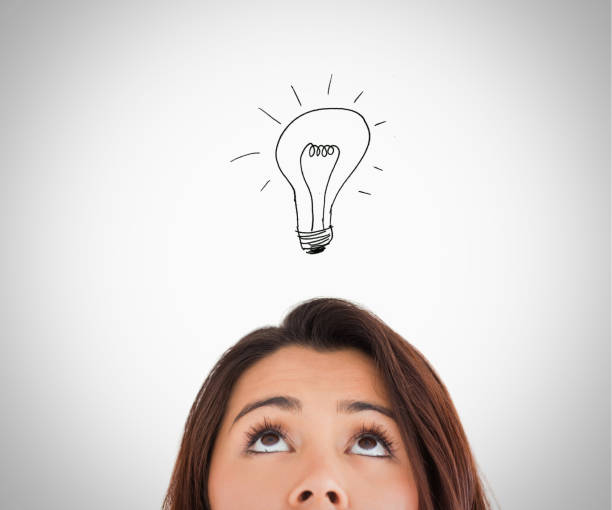 istock Brunette woman looking up on the bulb 848123468