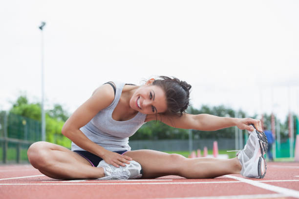 istock Smiling woman stretching on a track 848126180