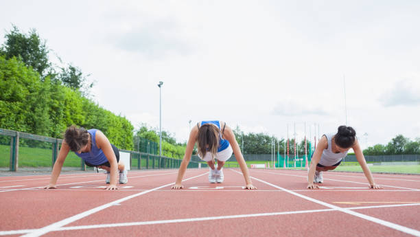 istock Three women stretching on running track 848126432