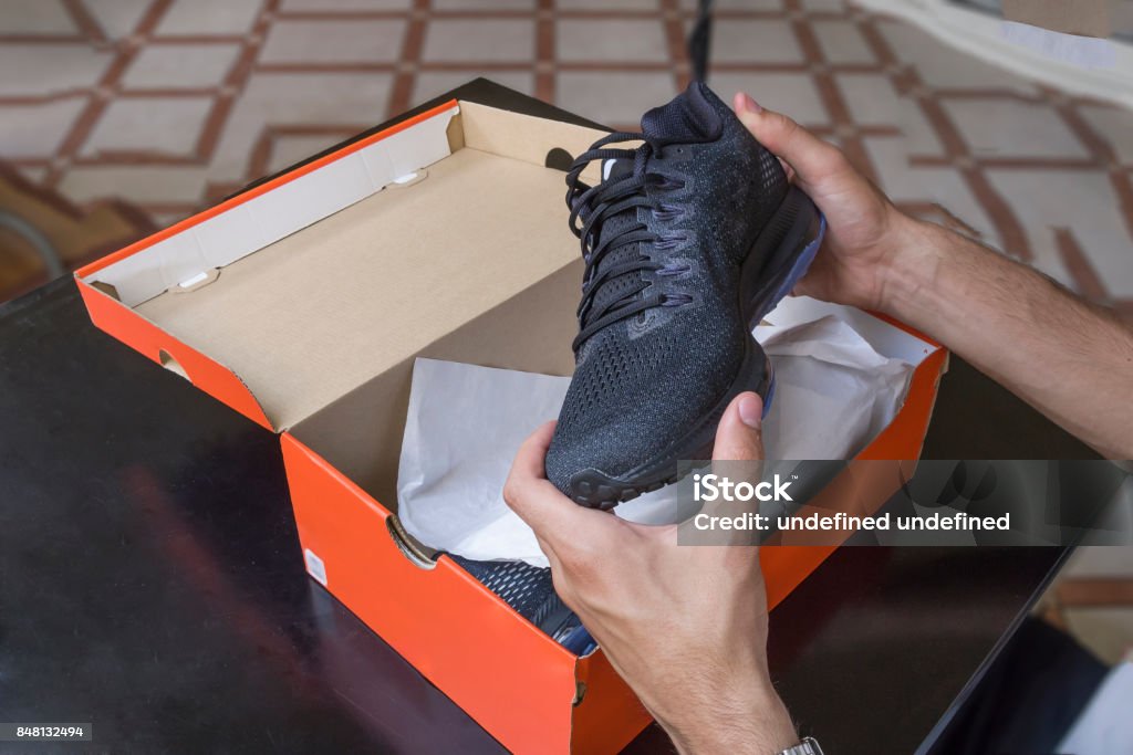 Shoes box Opening the box of a new pair of shoes Shoe Stock Photo