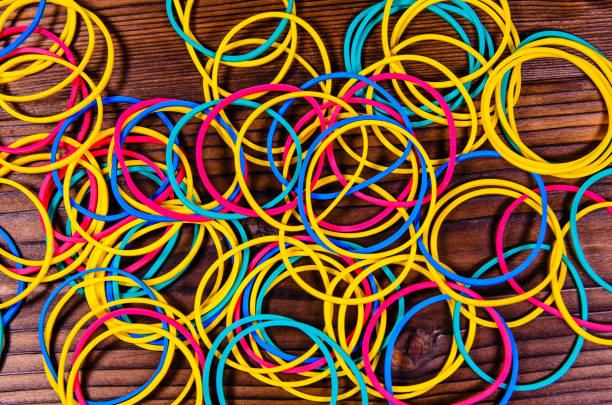 istock Multicolored rubber bands on wooden table. Top view 848135934