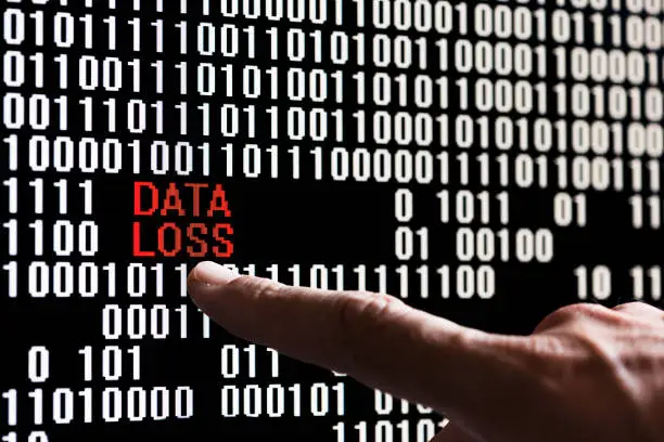 Photo of Finger pointing bank account data in binary code