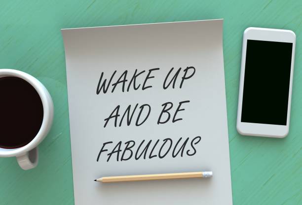 istock Wake Up And Be Fabulous, message on paper, smart phone and coffee on table, 3D rendering 848142556
