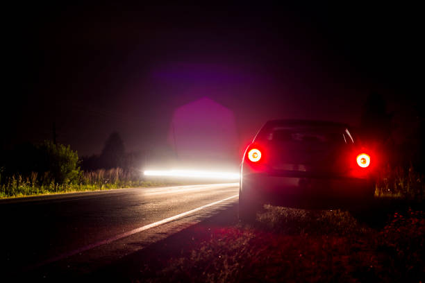 istock Car parked on the road late at night 848142724