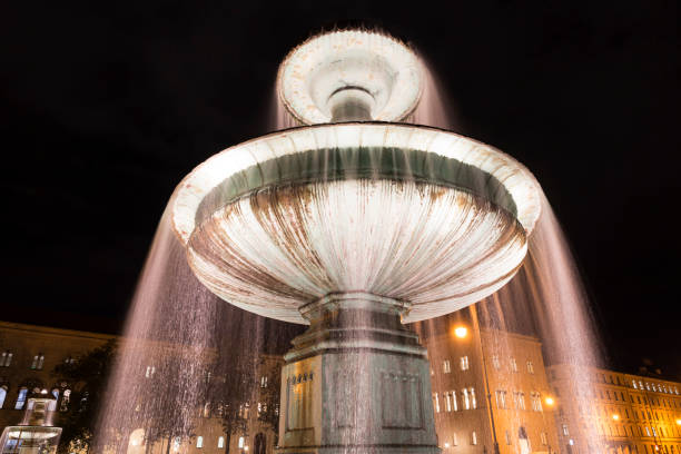 istock Illuminated fountain in downtown Munich, Germany 848143526