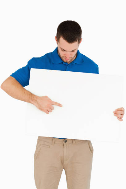 istock Young salesman pointing at banner he is holding 848146668