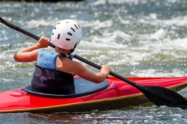 rafting and kayaking. a very young athlete improves his skills in running a kayak on a river with a rapid current. - sports team sport rowing teamwork rafting imagens e fotografias de stock