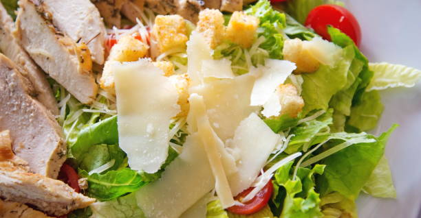 istock Caesar salad with chicken, selection of cheese, and cherry tomatoes. Top view 848159882
