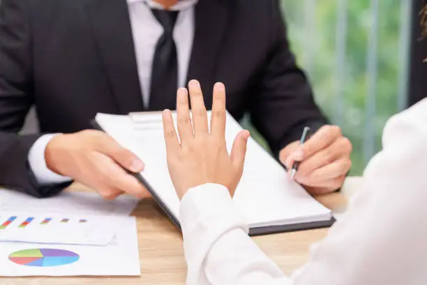 Photo of Customer or woman says no or hold on when businessman giving pen for signing a contract