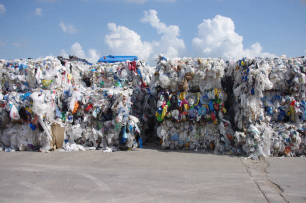 Bales of ridged and film plastics consolidated and prepared to be shipped for processing into post consumer recycled resin stock photo