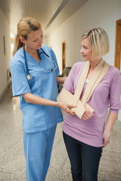 istock Nurse touching broken arm of patient 848184302