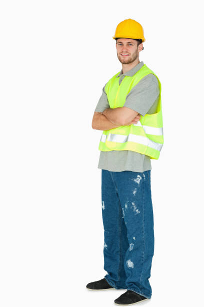 istock Side view of smiling young construction worker with arms folded 848184756