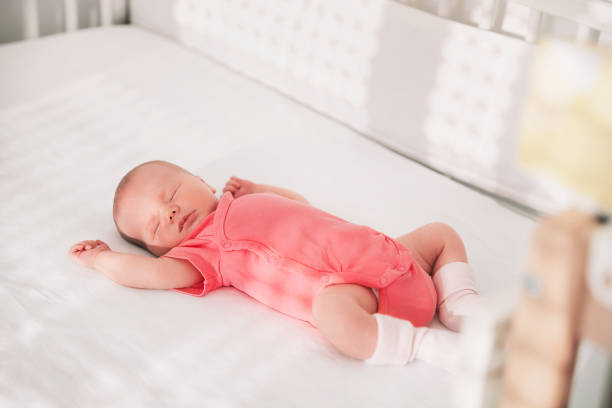 Newborn baby girl sleep first days of life. Newborn baby girl sleep first days of life. Cute little newborn child sleeping peacefully crib photos stock pictures, royalty-free photos & images
