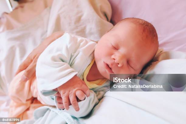 Mother Holding Her Newborn Baby Child After Labor In A Hospital Stock Photo - Download Image Now