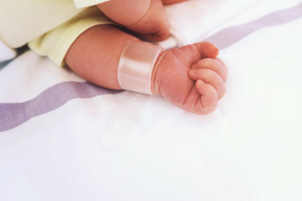 istock Newborn close-up with name tag bracelet. 848187940