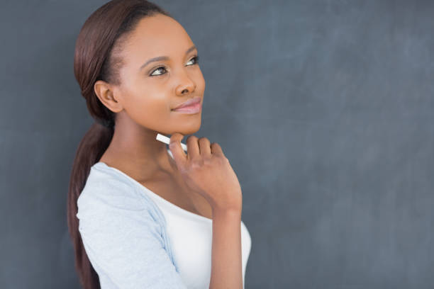istock Thoughtful black woman holding a chalk 848188106