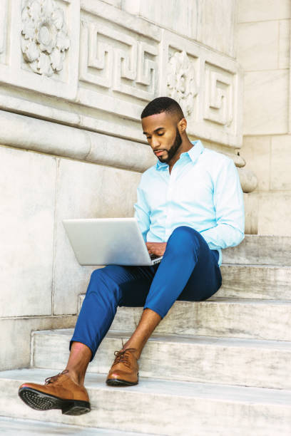istock Young African American graduate student with beard studying in New York 848208888