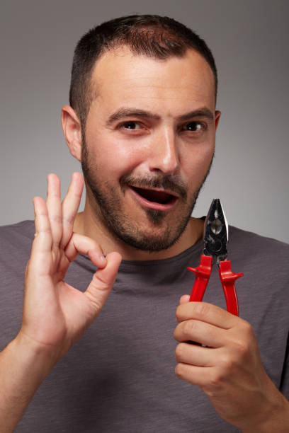 istock fool man showing pliers and make a bizarre face 848226444