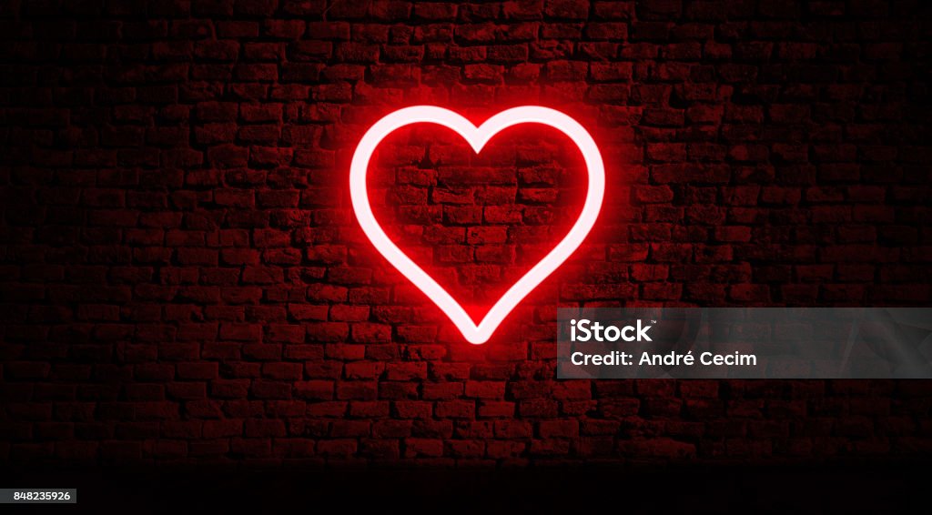Neon heart on brick wall Color Light Sign Heart Shape Stock Photo