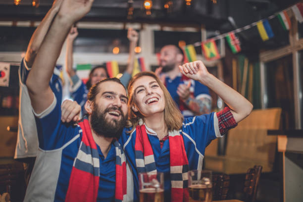 istock Couple watching game in bar 848240356