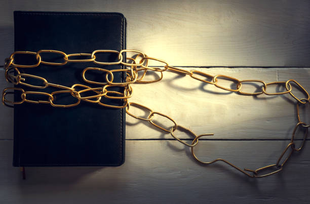 istock notebook and chain, on a wooden background, the top view 848248382