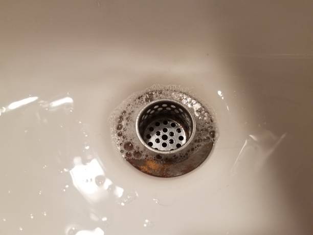 istock bathroom sink with drain and water and soap bubbles 848252470