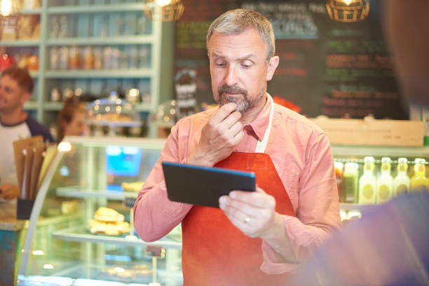 istock coffee shop owner checking his online accounts 848252480