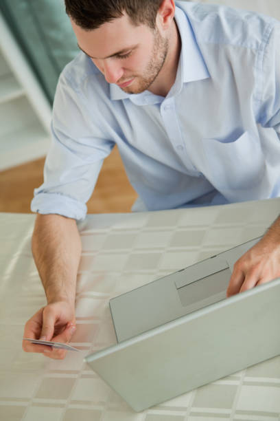 istock Businessman with credit card on his notebook 848271032